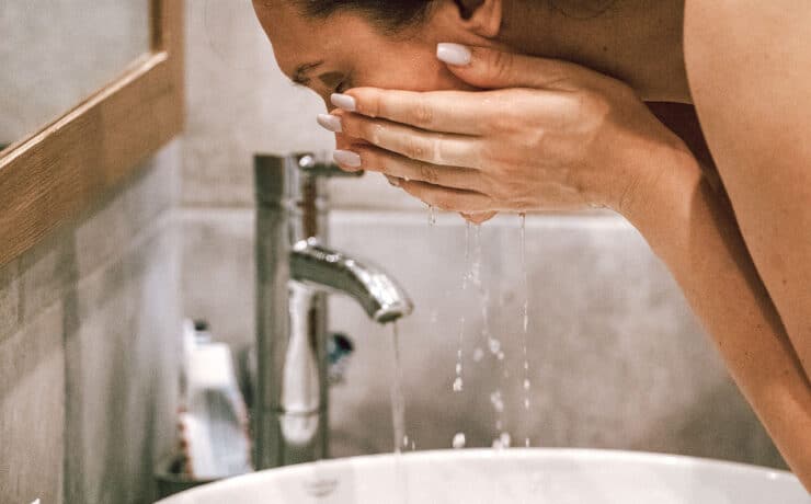 Woman Exfoliating Face